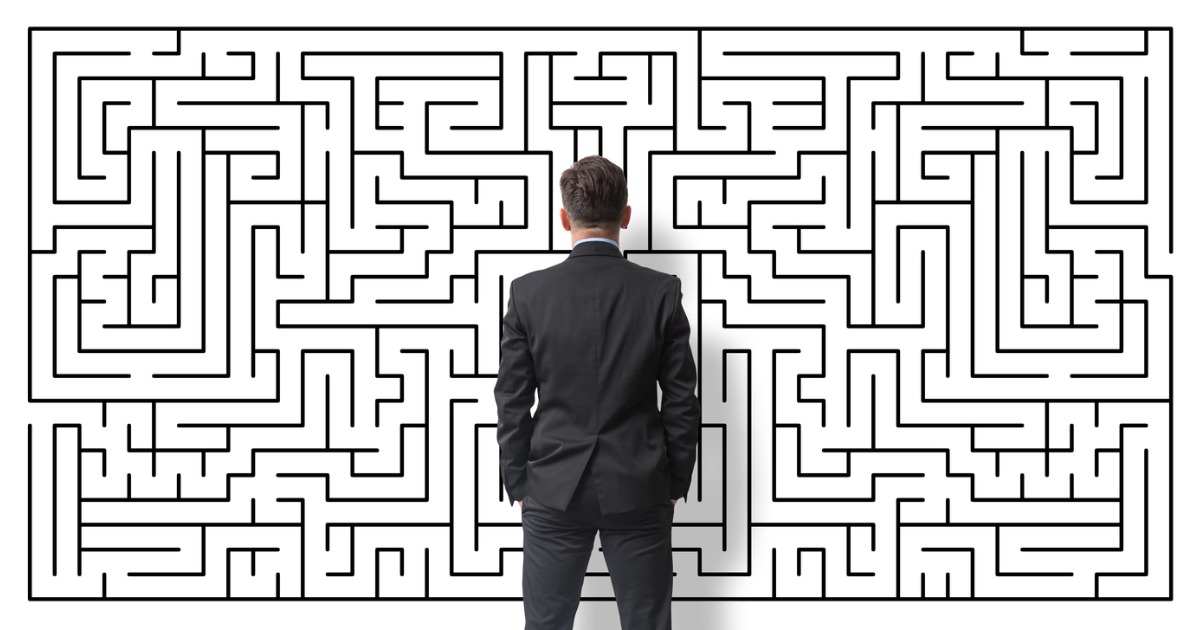 Man in Suit Back Turned Standing in Front of Maze